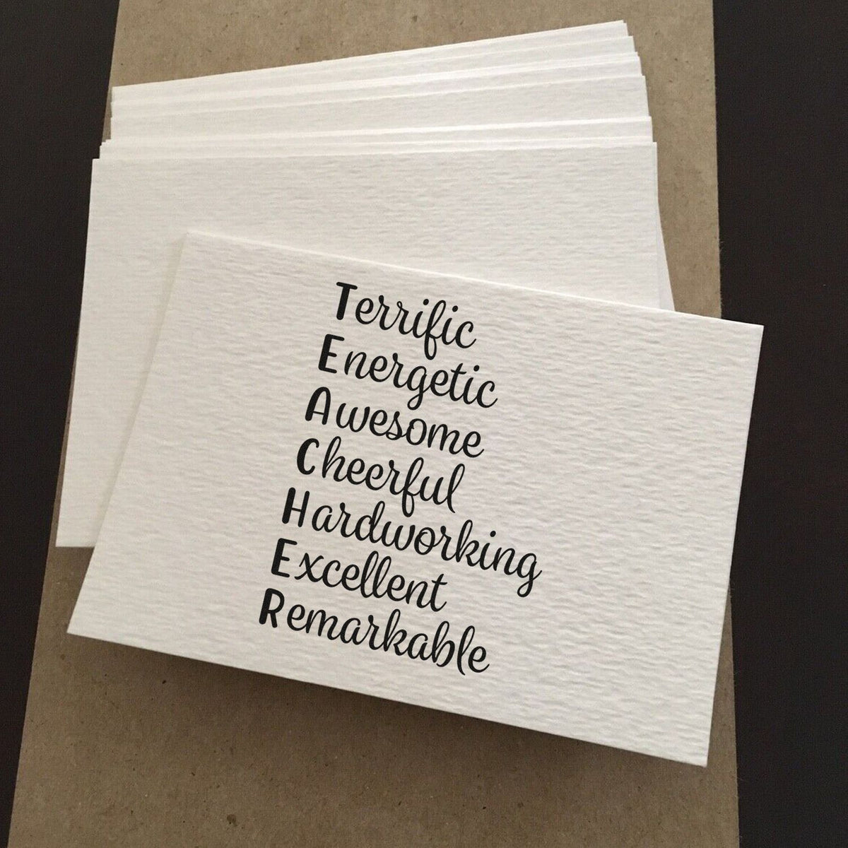 White textured stamp and seal sample with black script words: Terrific, Energetic, Awesome, Cheerful, Hardworking, Remarkable.