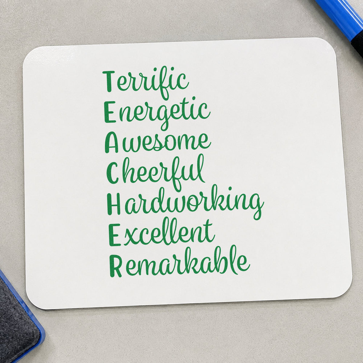 Teacher Positive Traits Acrostic craft stamp imprint in green ink on a handmade project, one idea being framed letter wall.