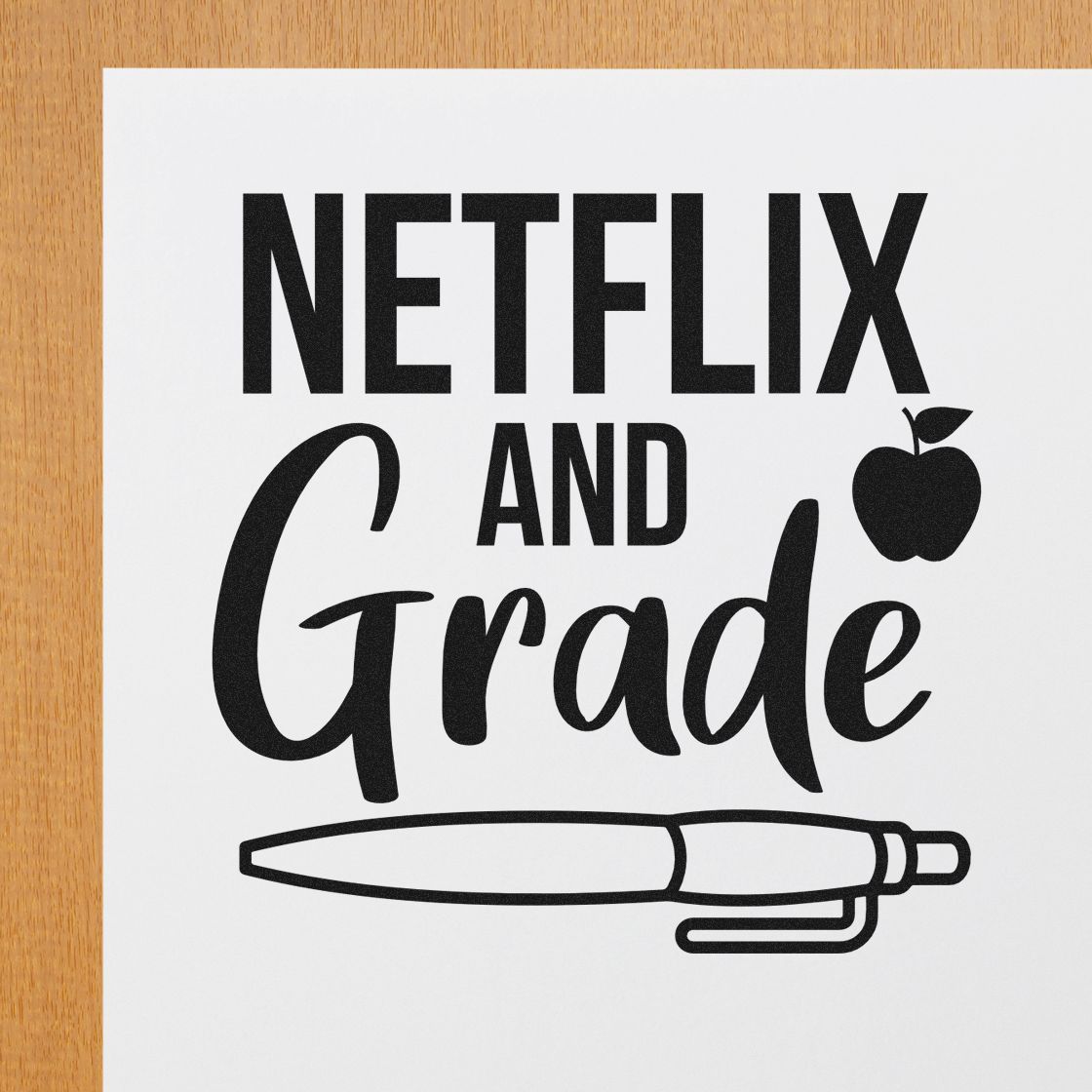 Black Netflix and Grade stamp and seal design on white paper with apple icon and pen outline, on wood background.