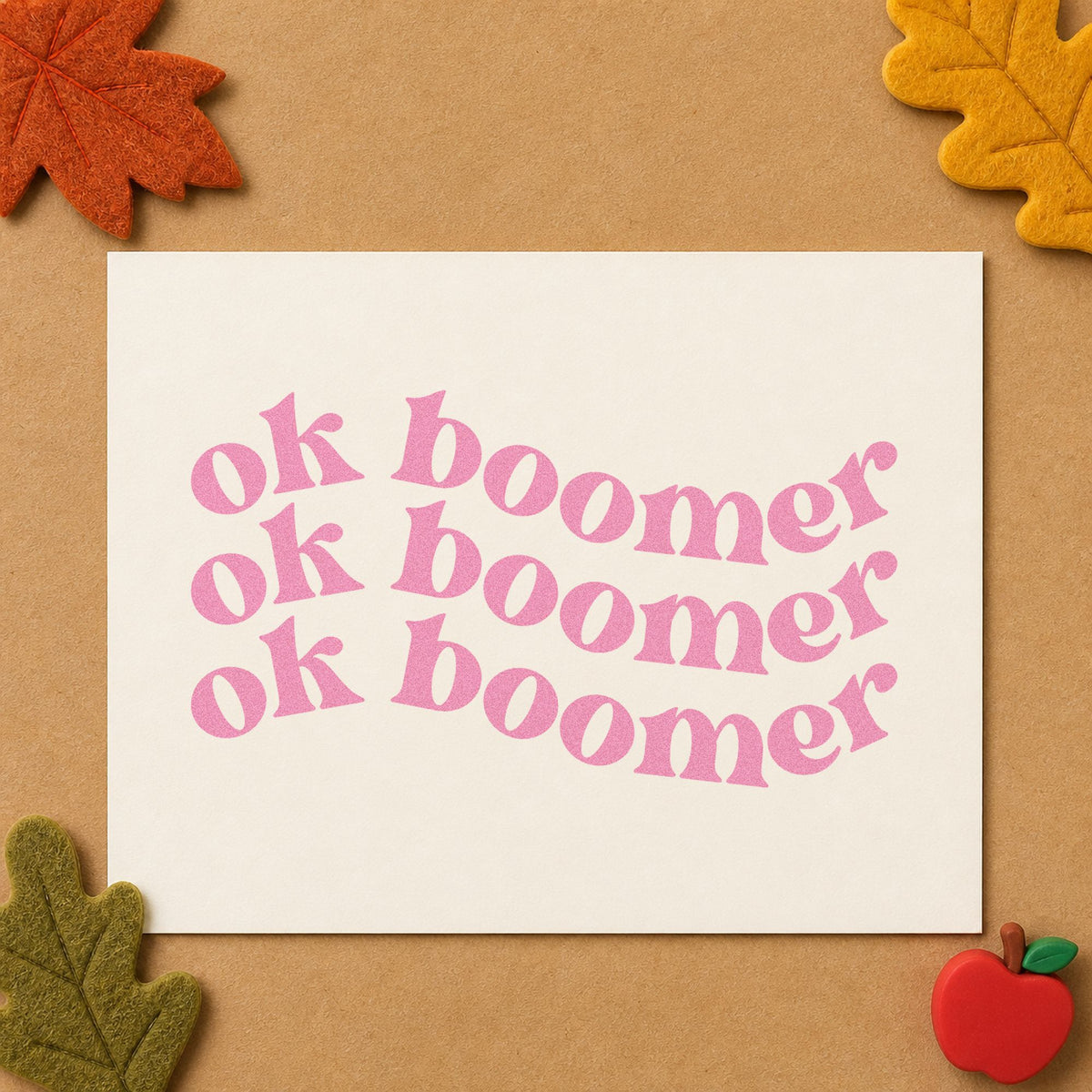 Repeated Wavy Ok Boomer craft stamp in purple ink on cardstock, an easy option for staffroom swap tags.