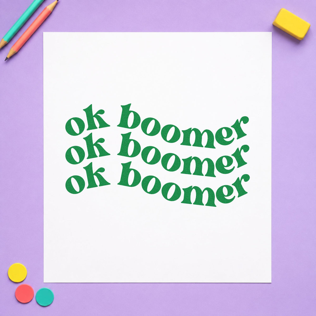 Repeated Wavy Ok Boomer craft stamp imprint in green ink on a handmade project, one idea being debate topic pages.