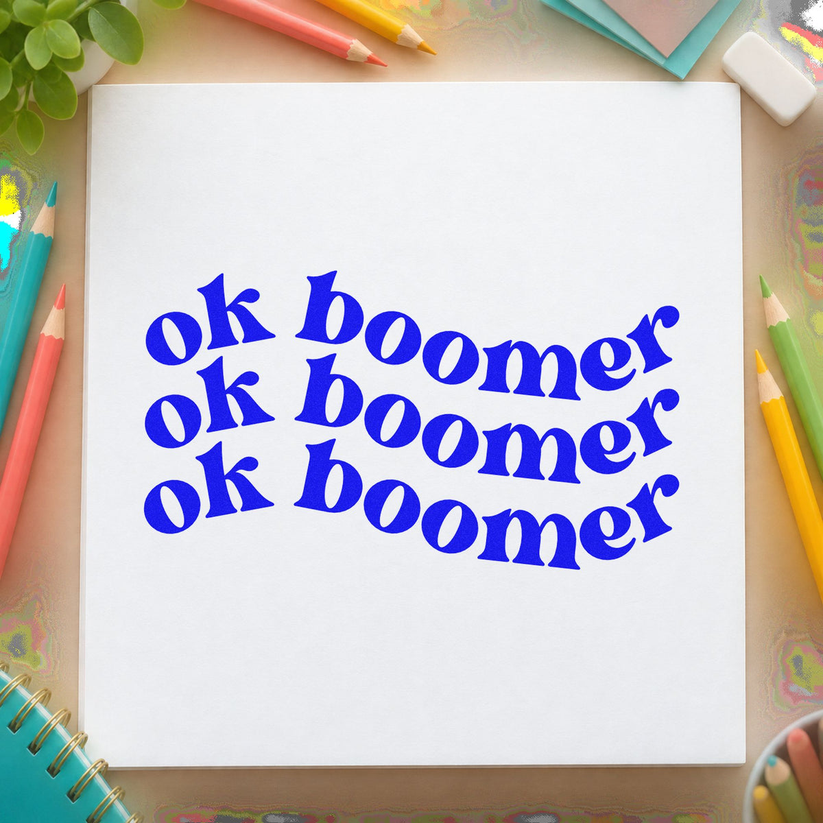 Repeated Wavy Ok Boomer craft stamp in blue ink on cardstock, an easy option for slogan tee panels.