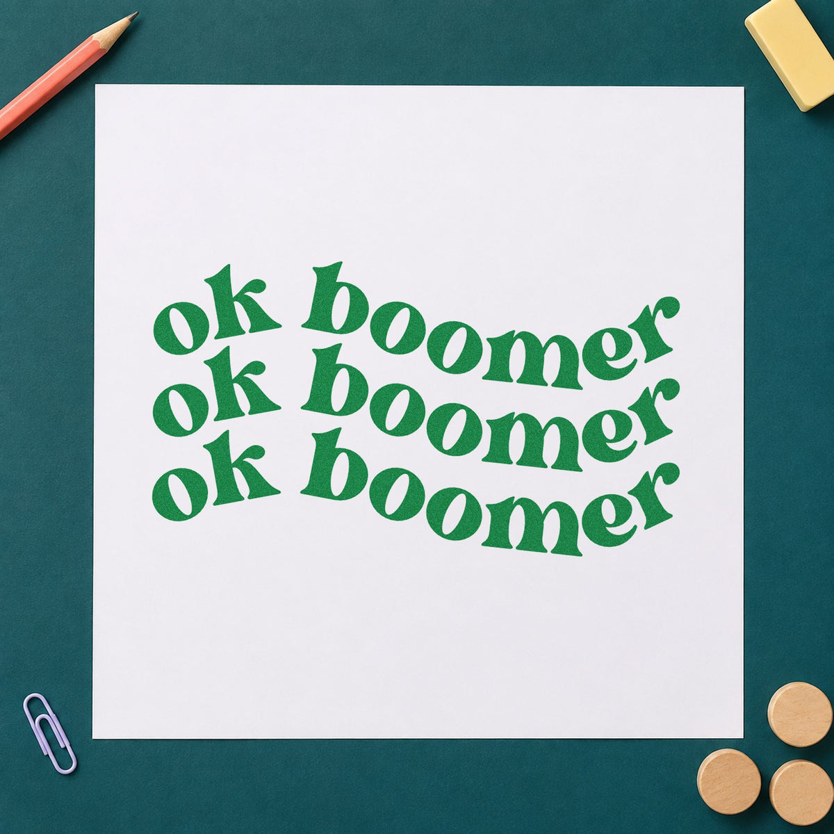 Repeated Wavy Ok Boomer craft stamp imprint in green ink on a handmade project, one idea being framed common room.