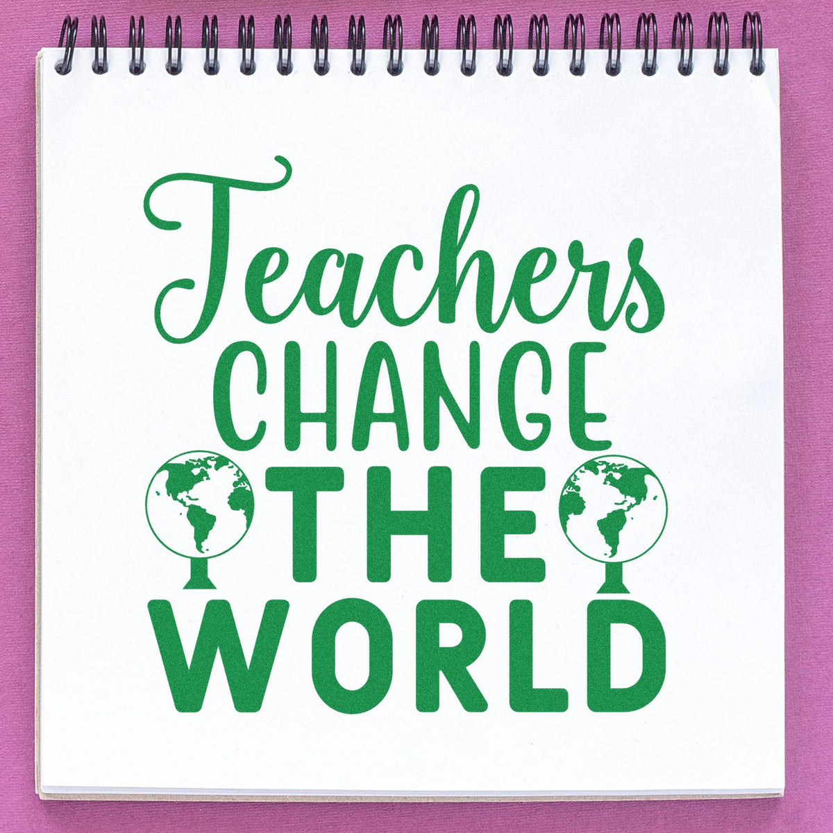 Green Teachers Change the World stamp design with globe icons on a white spiral notebook against a pink background.