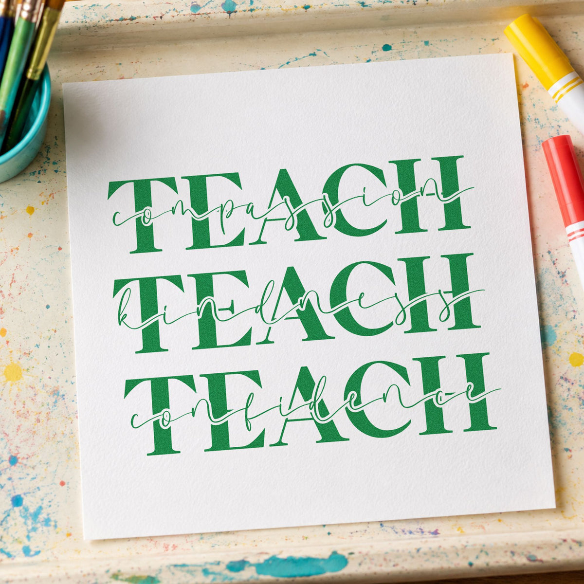 Teach Compassion Kindness Confidence craft stamp imprint in green ink on a handmade project, one idea being framed ethos wall.