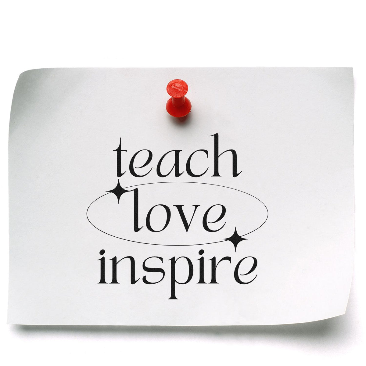 White paper stamp/seal design pinned with a red pushpin, black teach love inspire text, oval outline and sparkles
