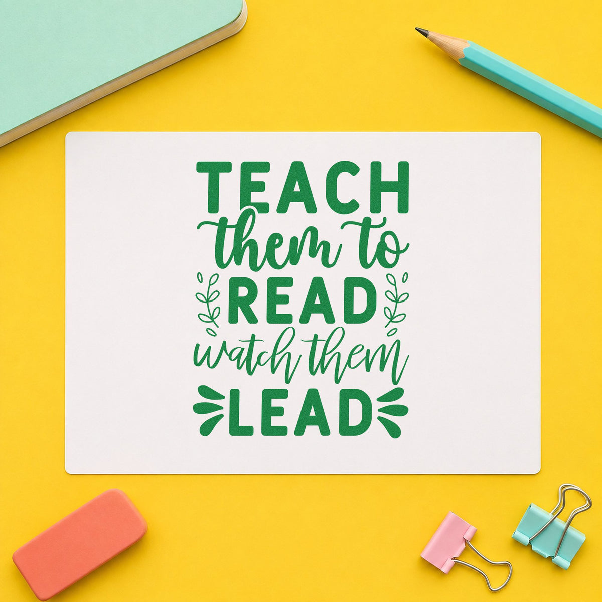 Teach Read Watch Lead craft stamp imprint in green ink on a handmade project, one idea being reading log pages.