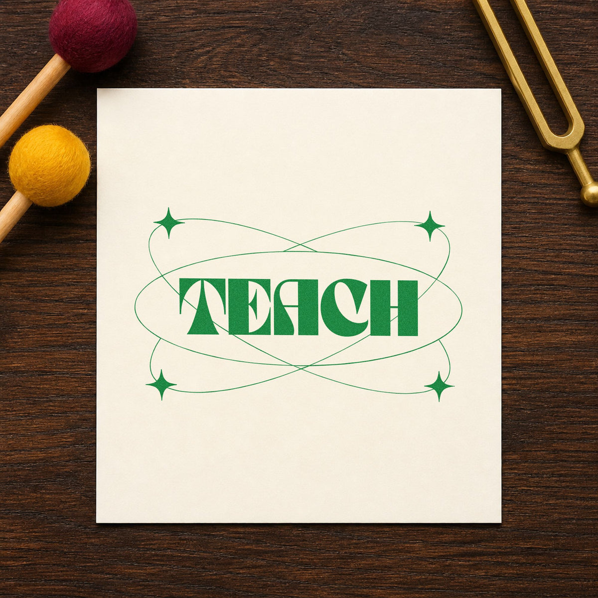 Teach With Orbit Sparkles craft stamp imprint in green ink on a handmade project, one idea being framed lab corridor.