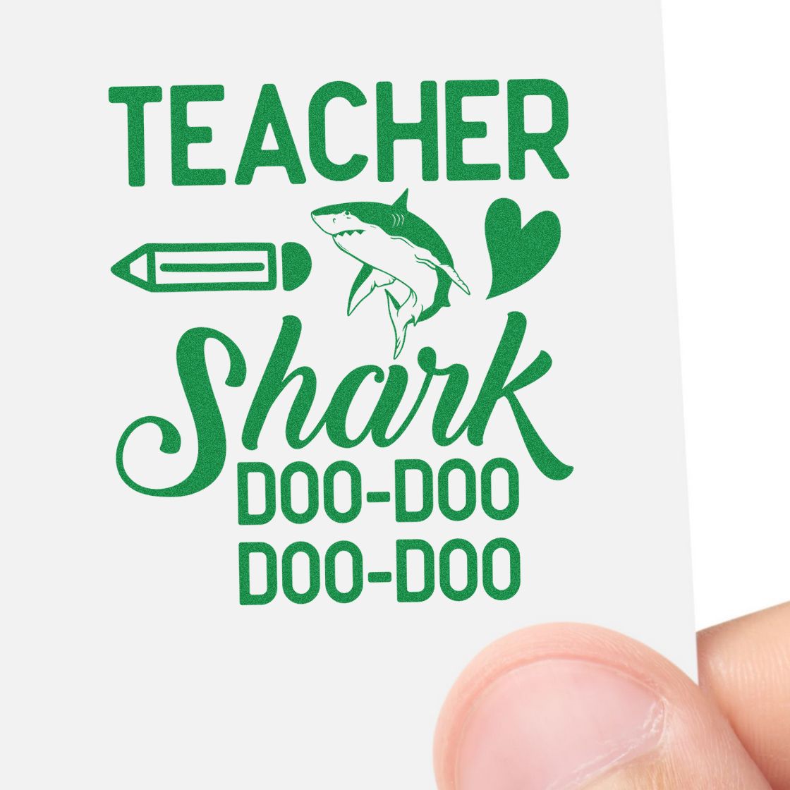 Green teacher stamp and seal with shark, pencil, heart, and Shark doo-doo text on white paper.