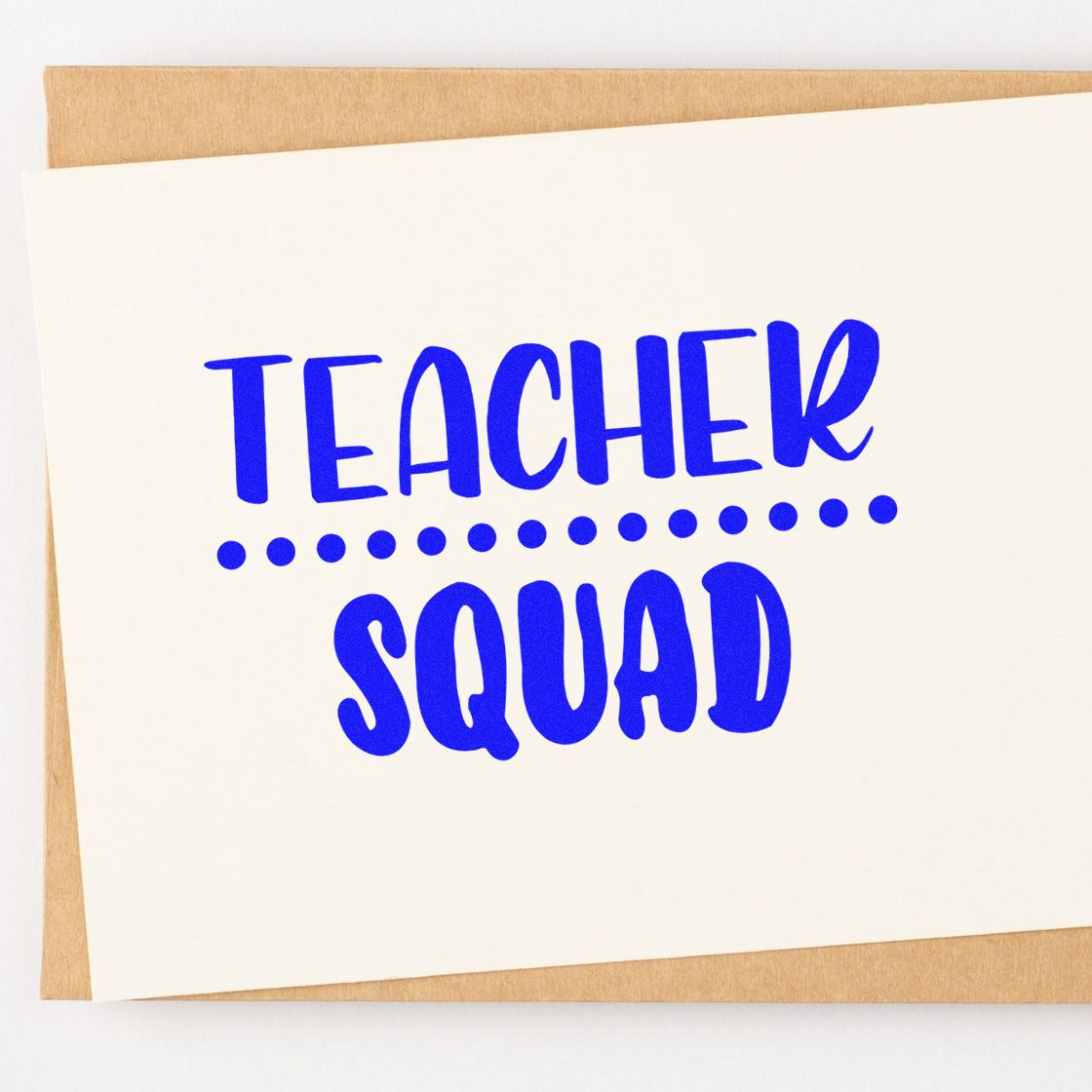 Blue Teacher Squad stamp seal in bold blue on a white card, with dotted divider over tan kraft paper.