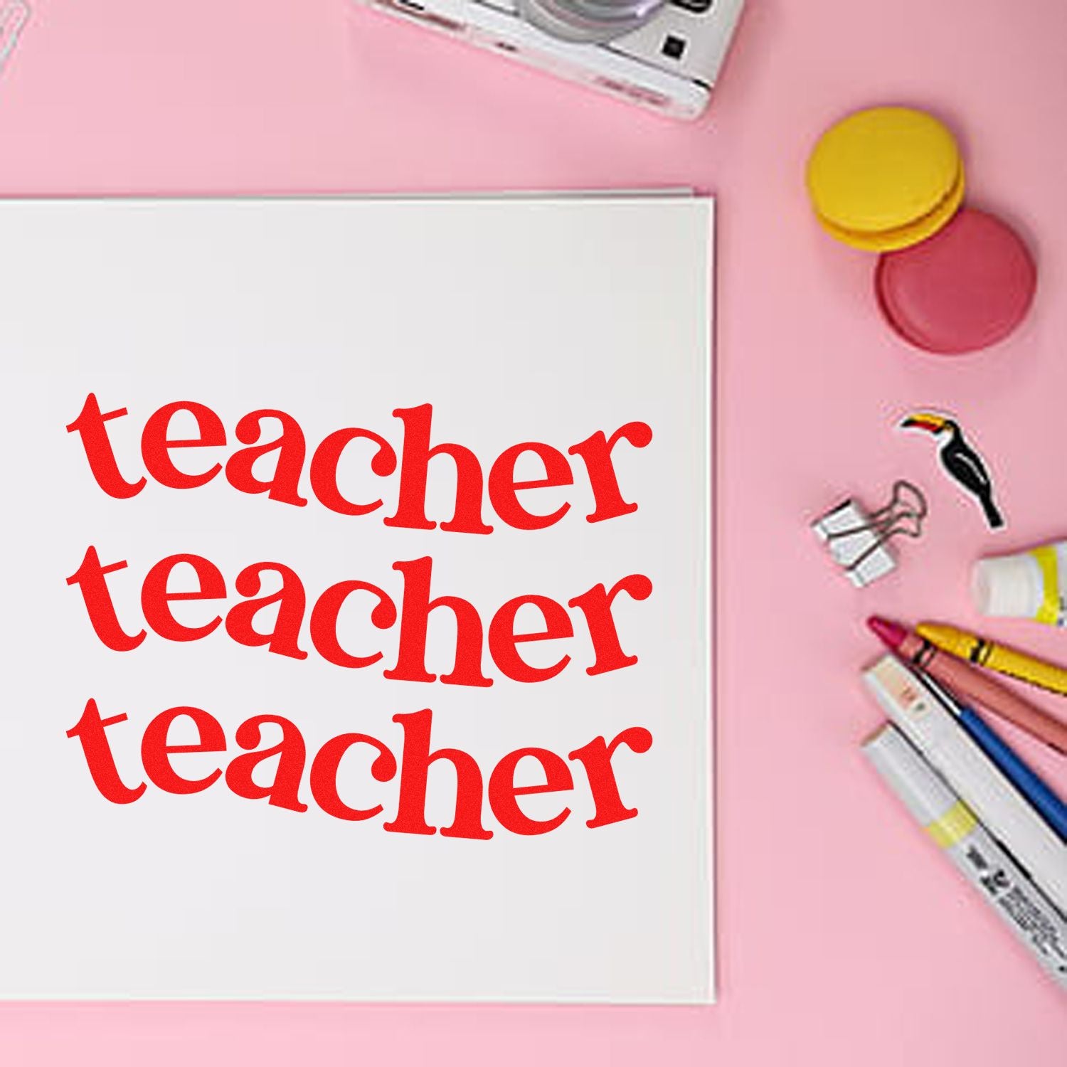 Teacher stamp and seal set showing red teacher impressions on white paper, with pink background, colored pens, and round stamp pads.