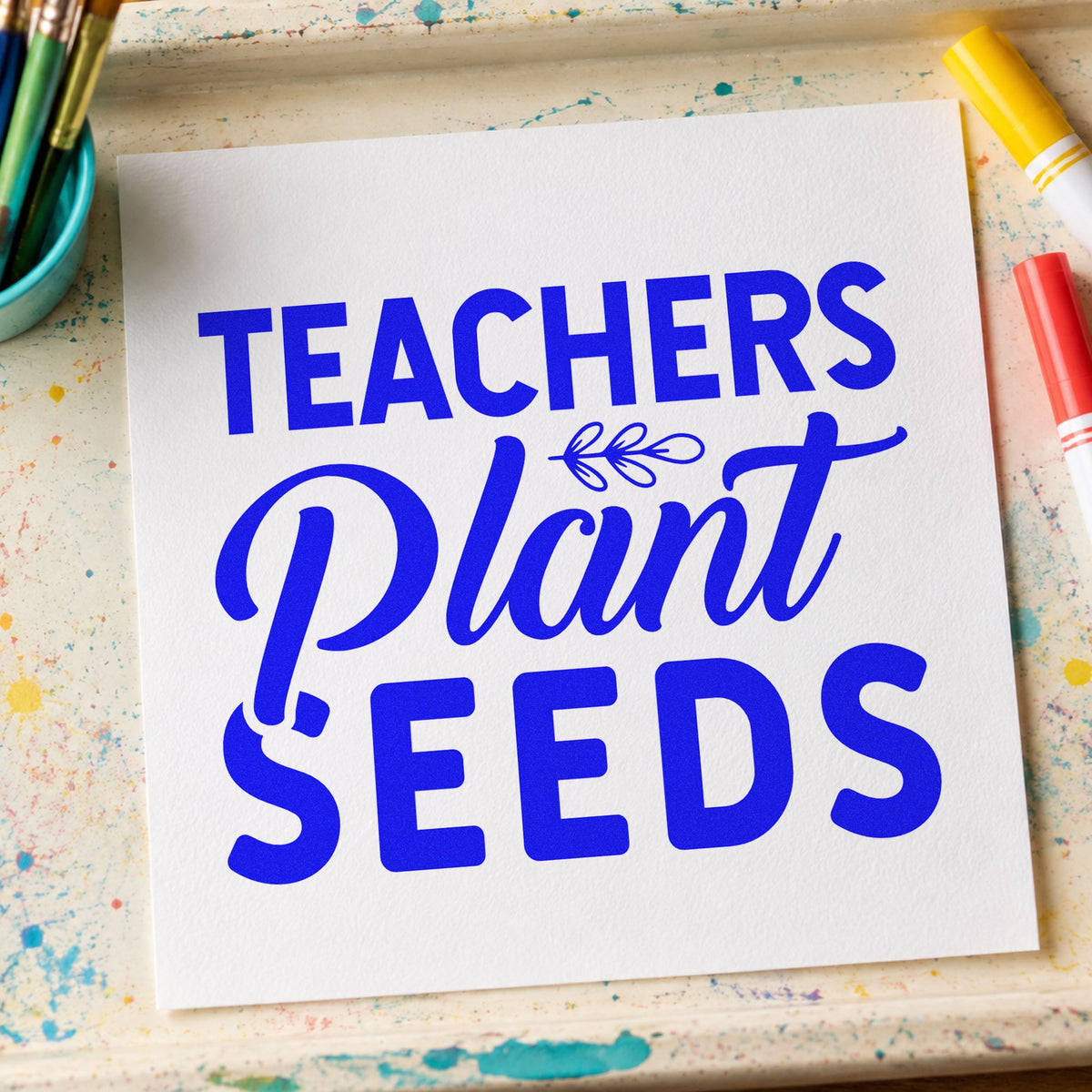 Teachers Plant Seeds Lettering craft stamp imprinted in blue ink on paper, a design suited to produce bag seals.