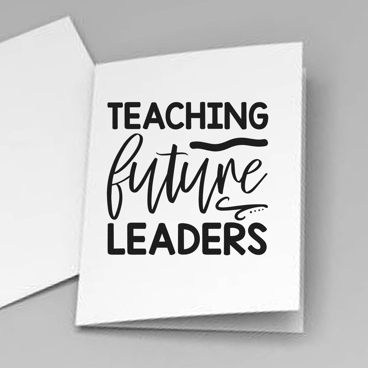 Black "Teaching Future Leaders" stamp on white card, with bold lettering and flowing script.