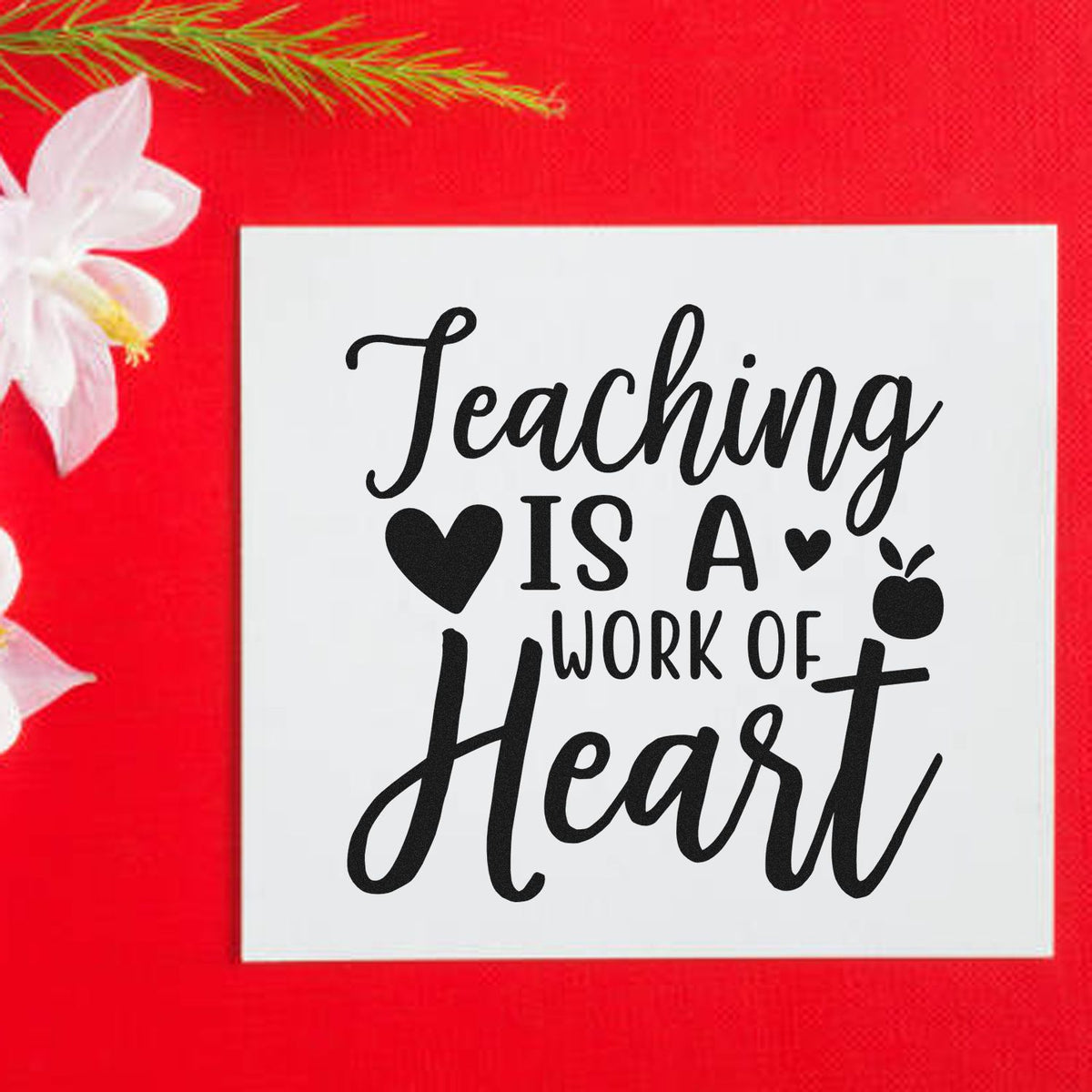 Black teacher stamp and seal reading Teaching is a work of heart on a white square, set against a bright red background.