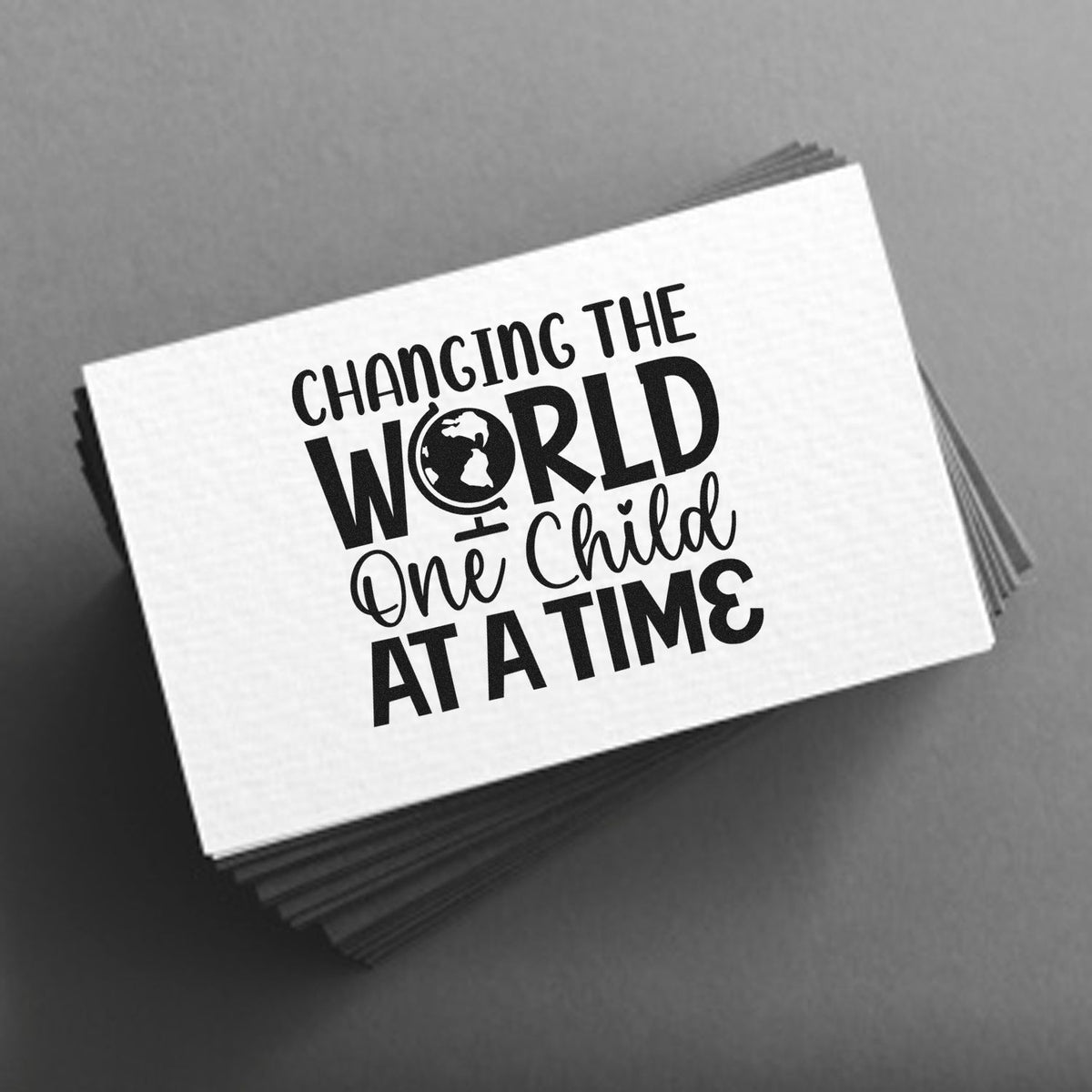 Black and white stamp and seal stack with Changing the World One Child at a Time and a globe icon.