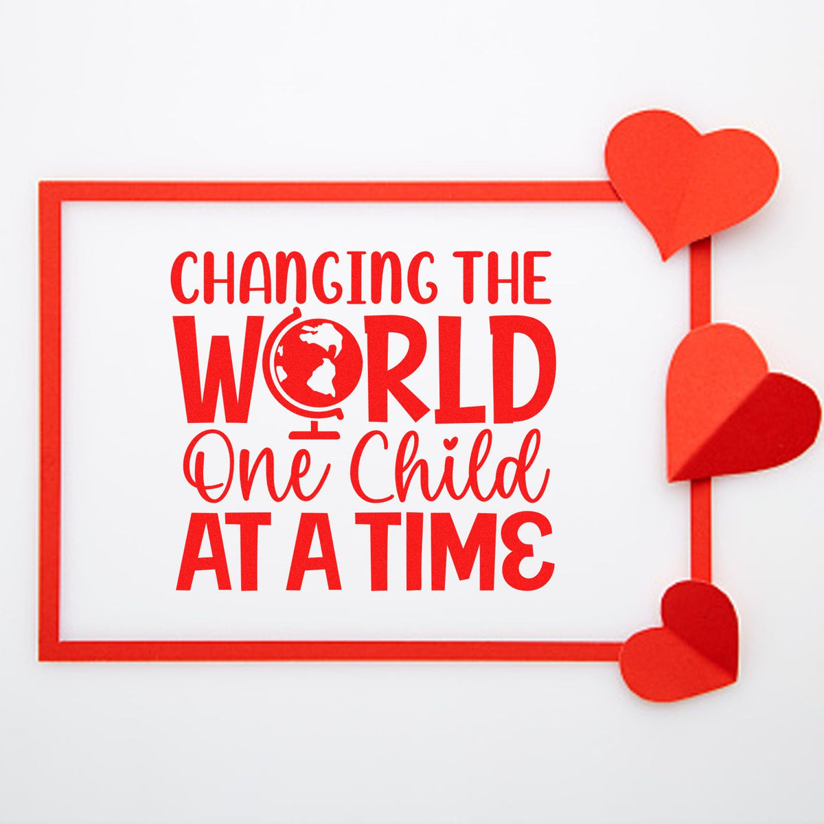 Red stamp-style seal with hearts and globe icon, reading Changing the World One Child at a Time in bold red text.