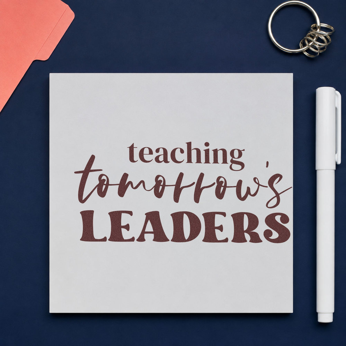 Teaching Tomorrow's Leaders rubber stamp printed in brown ink, ready for alumni board labels and similar paper crafts.