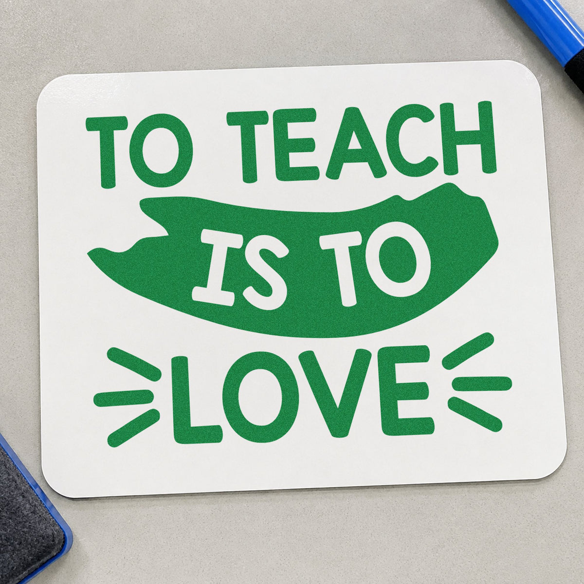 To Teach Is To Love craft stamp imprint in green ink on a handmade project, one idea being service order pages.