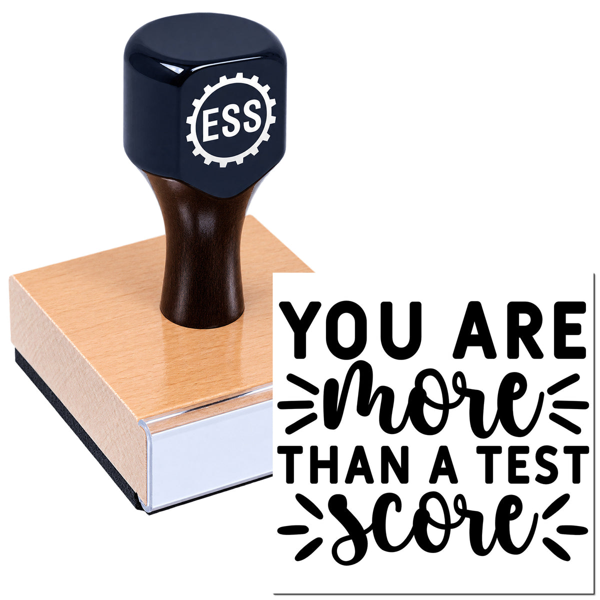 Dark navy ESS stamp on a wooden seal block beside "You are more than a test score" lettering.