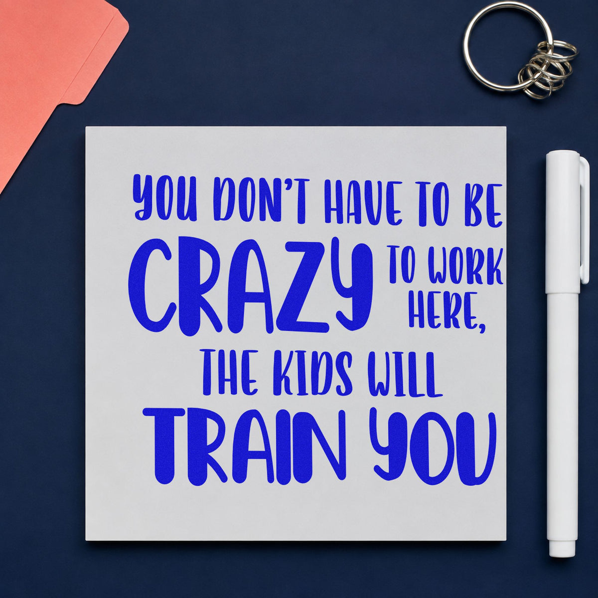 Crazy Kids Will Train You craft stamp in blue ink on cardstock, an easy option for apron front panels.