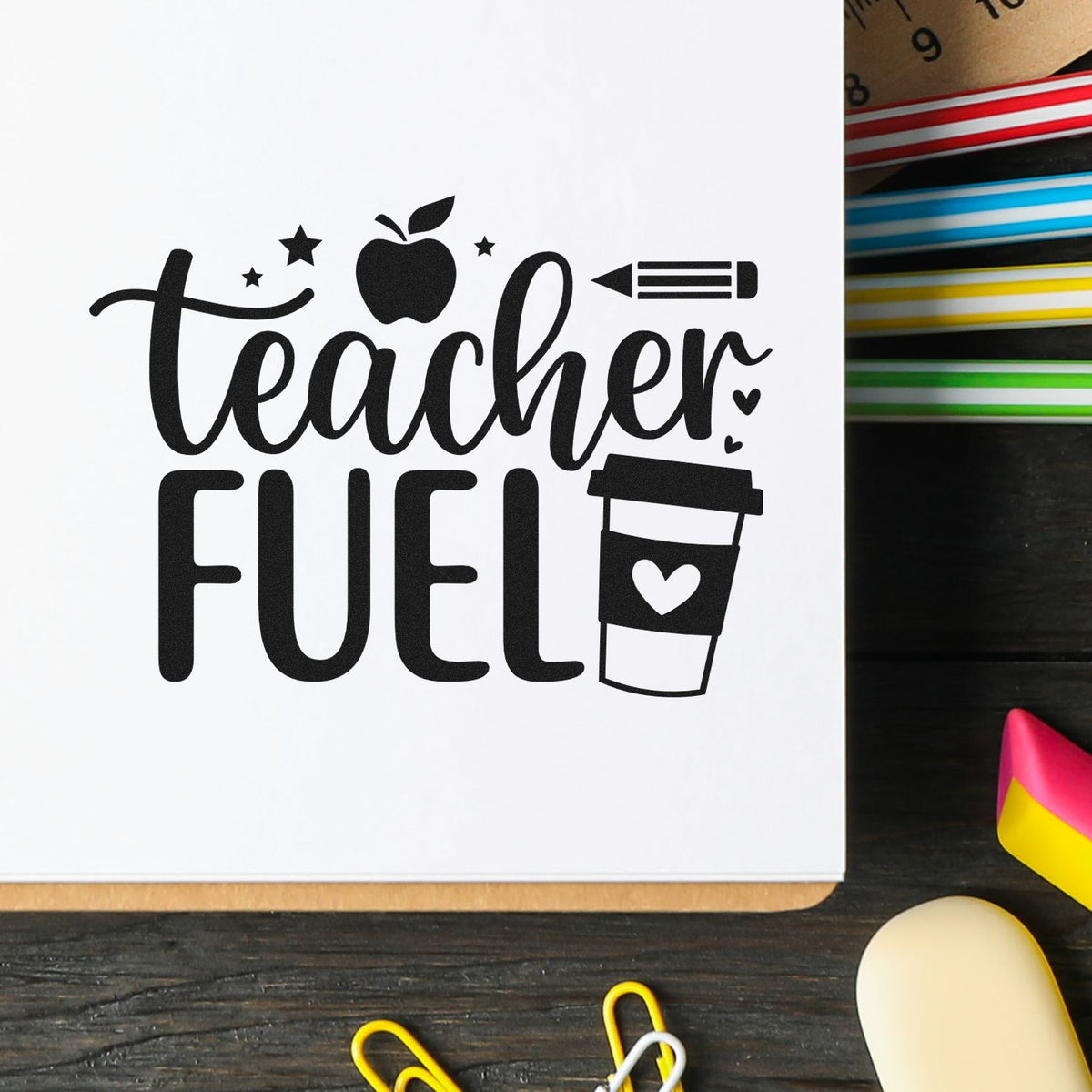 Black teacher fuel stamp and seal design with apple, pencil and coffee cup on white paper, beside colorful pens.