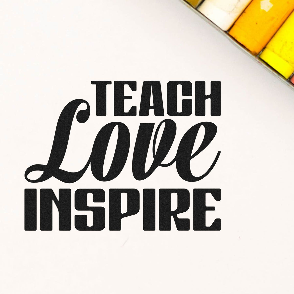 Black Teach Love Inspire stamp and seal design on white, with yellow and orange corner accents.