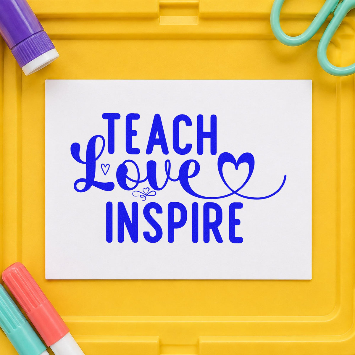 Teach Love Inspire Heart Flourish craft stamp in blue ink on cardstock, an easy option for ribbon sash panels.