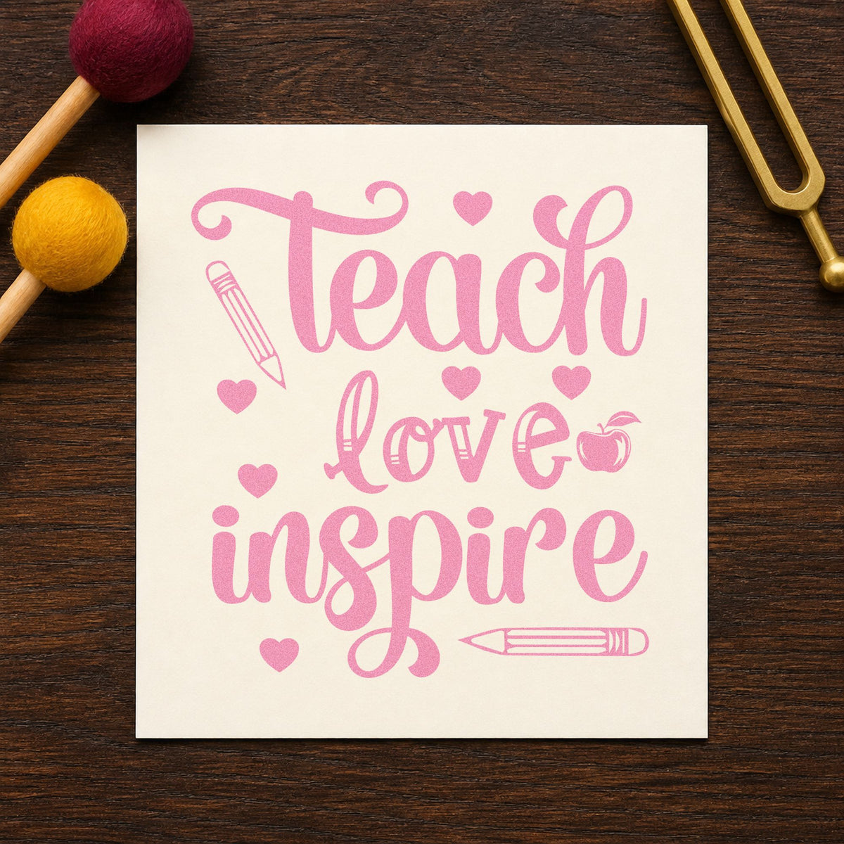 Teach Love Inspire Hearts craft stamp in purple ink on cardstock, an easy option for kit bundle tags.
