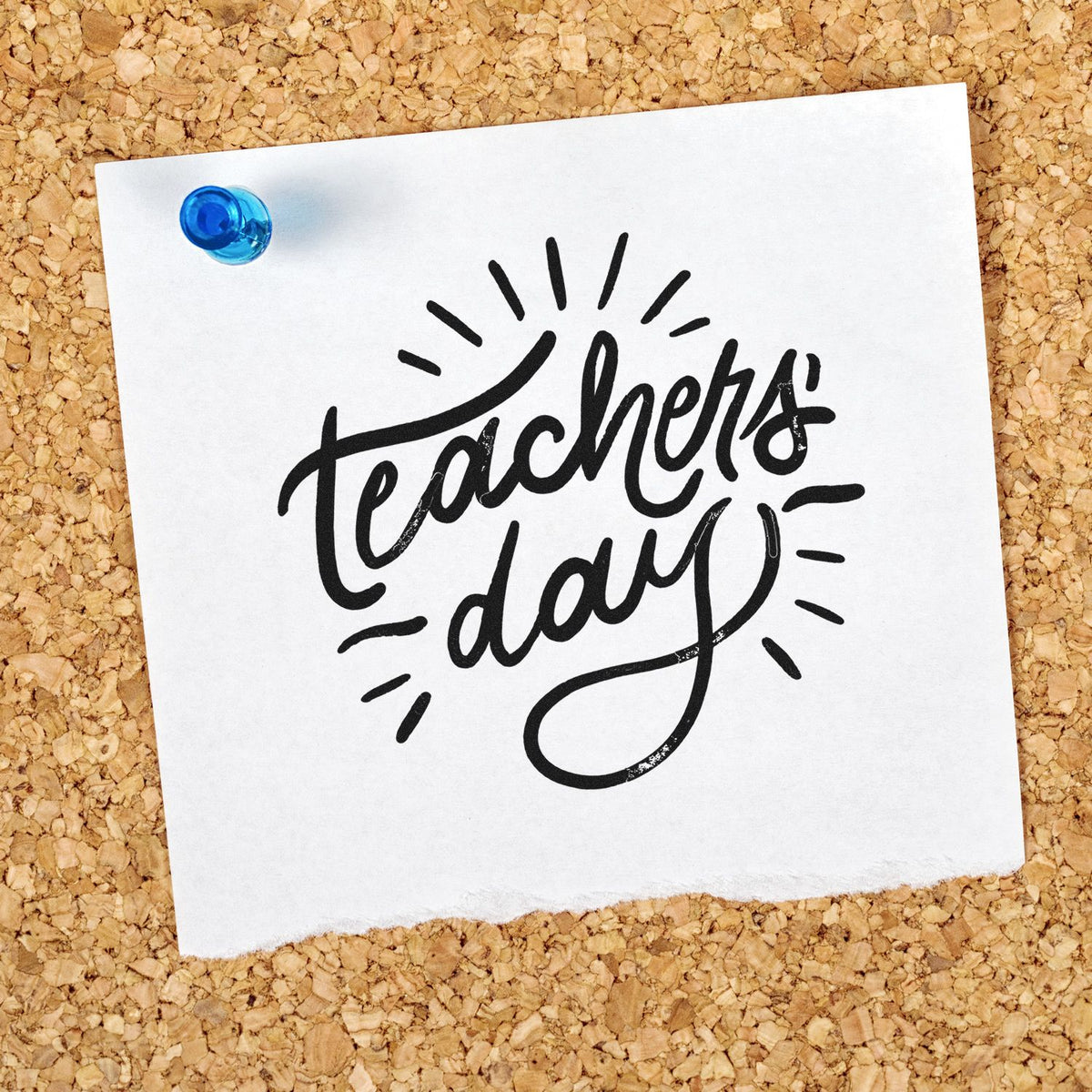 Black Teachers Day stamp and seal design on white paper pinned with blue tack over tan corkboard