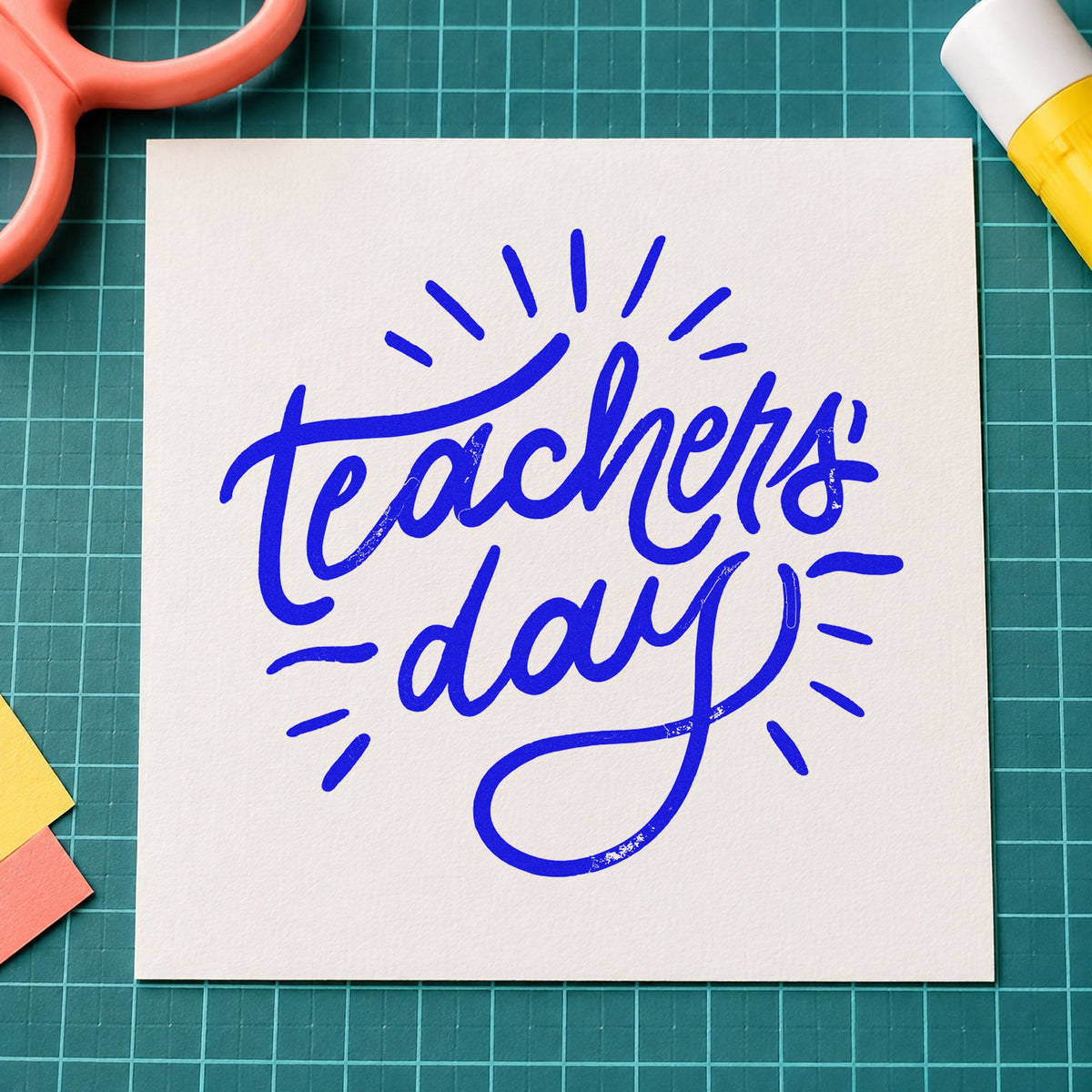 Teachers Day Radiating Script craft stamp imprinted in blue ink on paper, a design suited to posy wrap seals.
