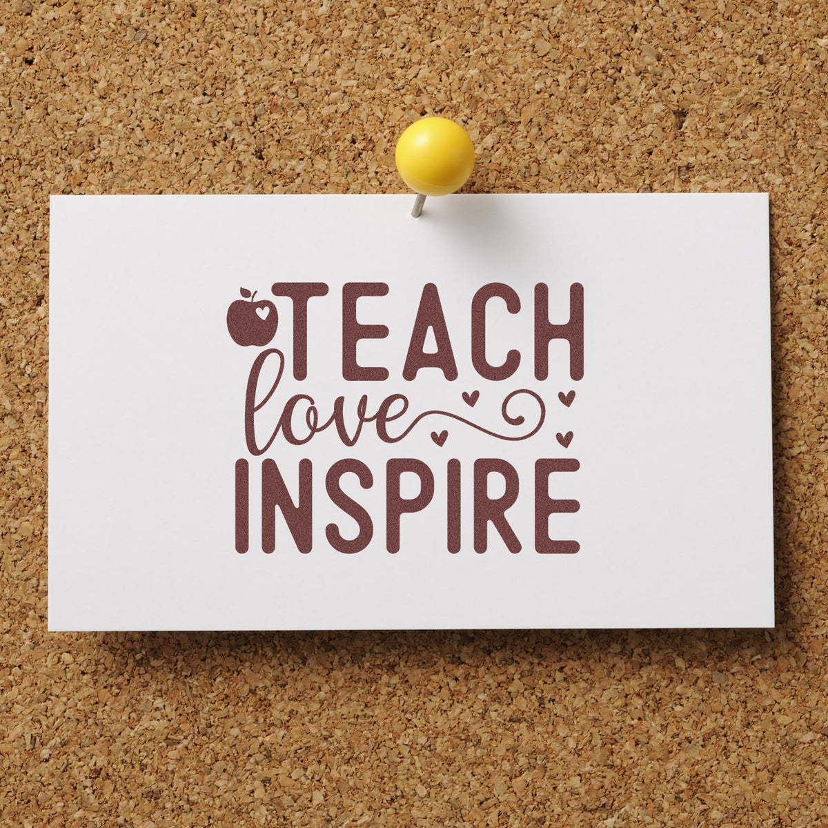White teacher stamp seal design pinned to corkboard, with maroon Teach love Inspire, apple icon, hearts, and a yellow pushpin.