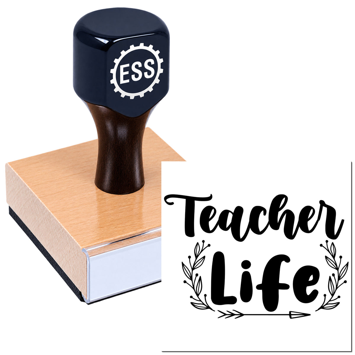 Black ESS stamp and seal on a wooden block, with bold "Teacher Life" script and decorative leaf accents.