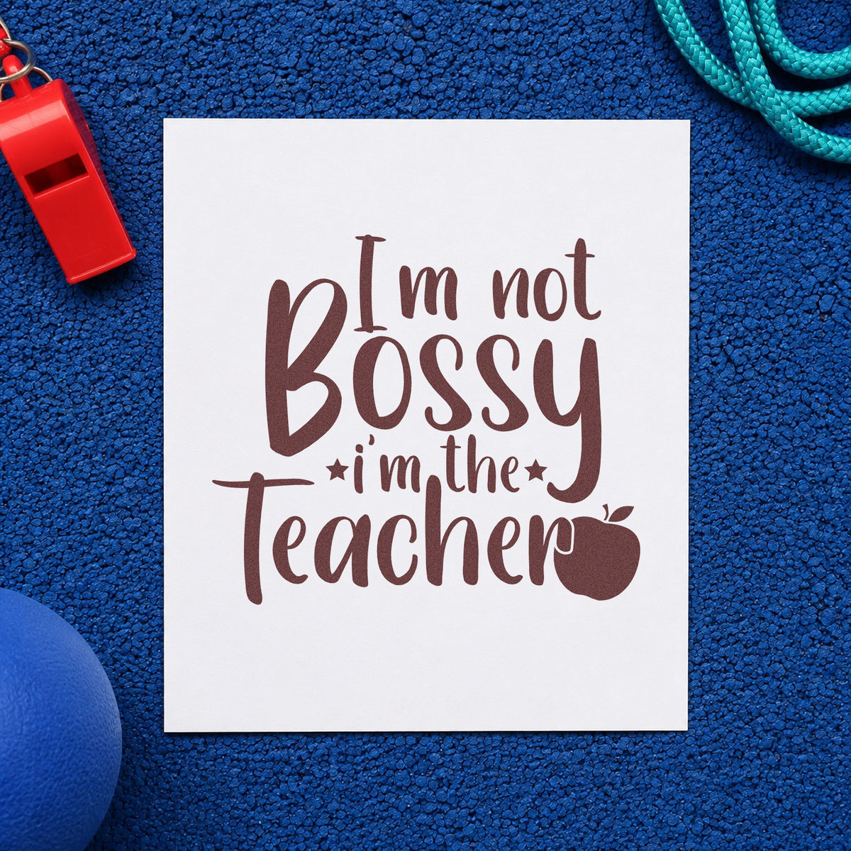 Not Bossy I'm The Teacher rubber stamp printed in brown ink, ready for cupboard key labels and similar paper crafts.