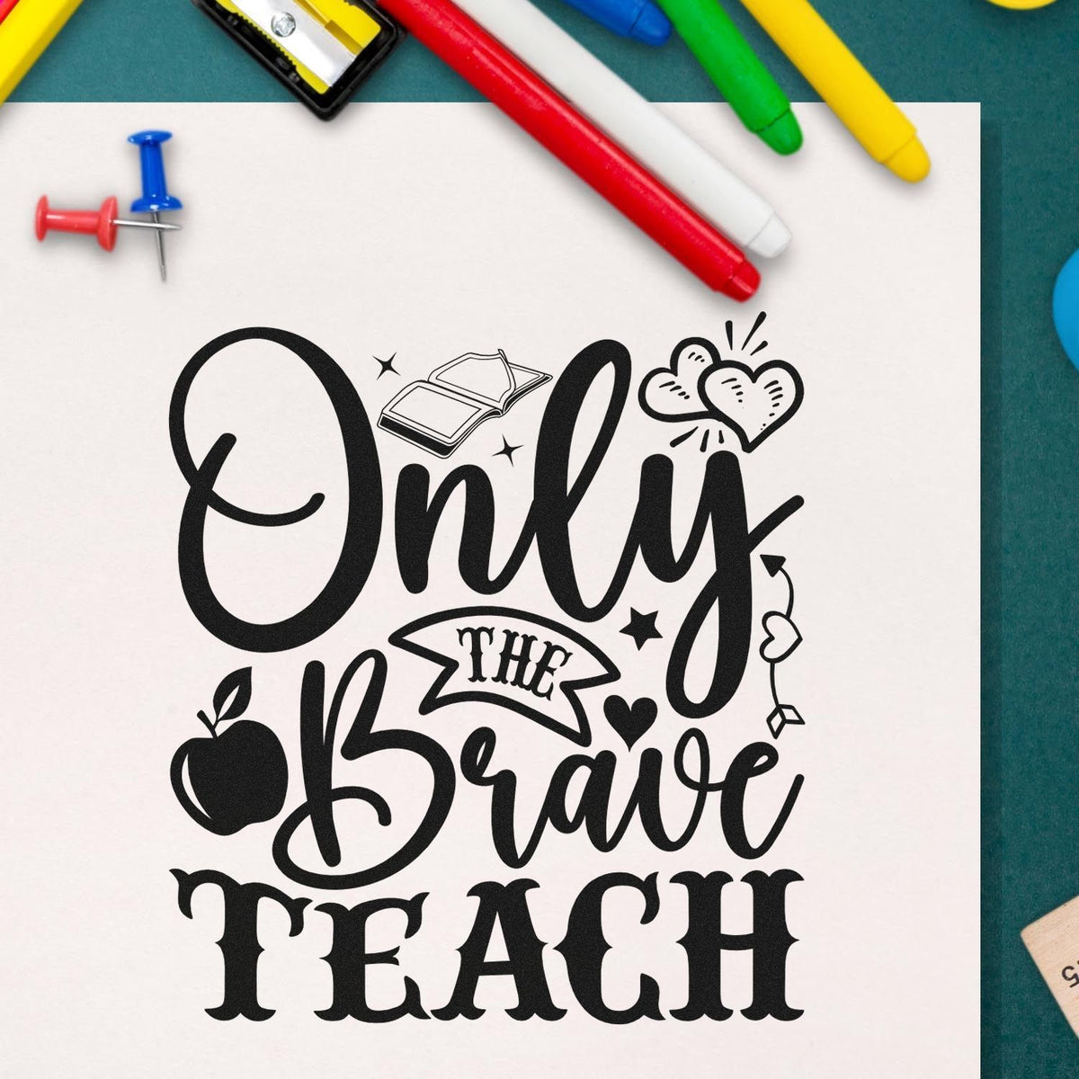 Black teacher stamp/seal design reading Only the Brave Teach with hearts, apple, and book, framed by colorful pens and push pins.