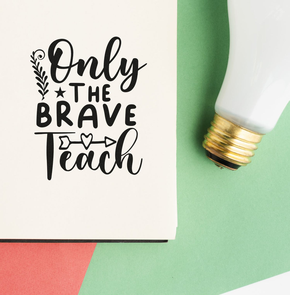 Black Only the Brave Teach stamp and seal product with heart-arrow design on white and mint green background.
