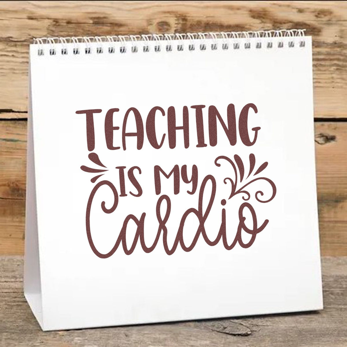 Custom burgundy stamp and seal with Teaching is my Cardio on a white spiral-top gift bag.