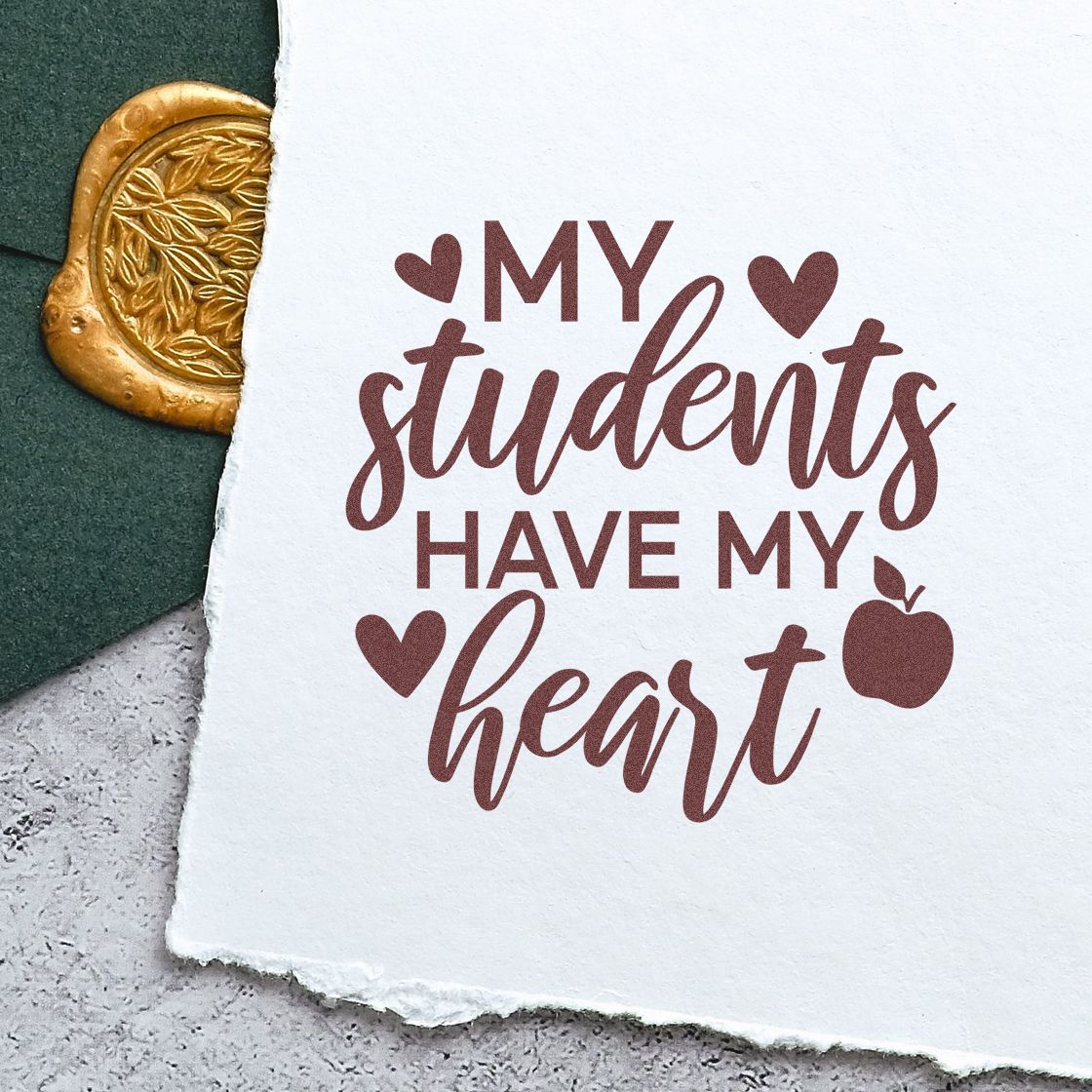 Burgundy My students have my heart stamp with hearts and apple, beside a gold embossed wax seal on white paper.