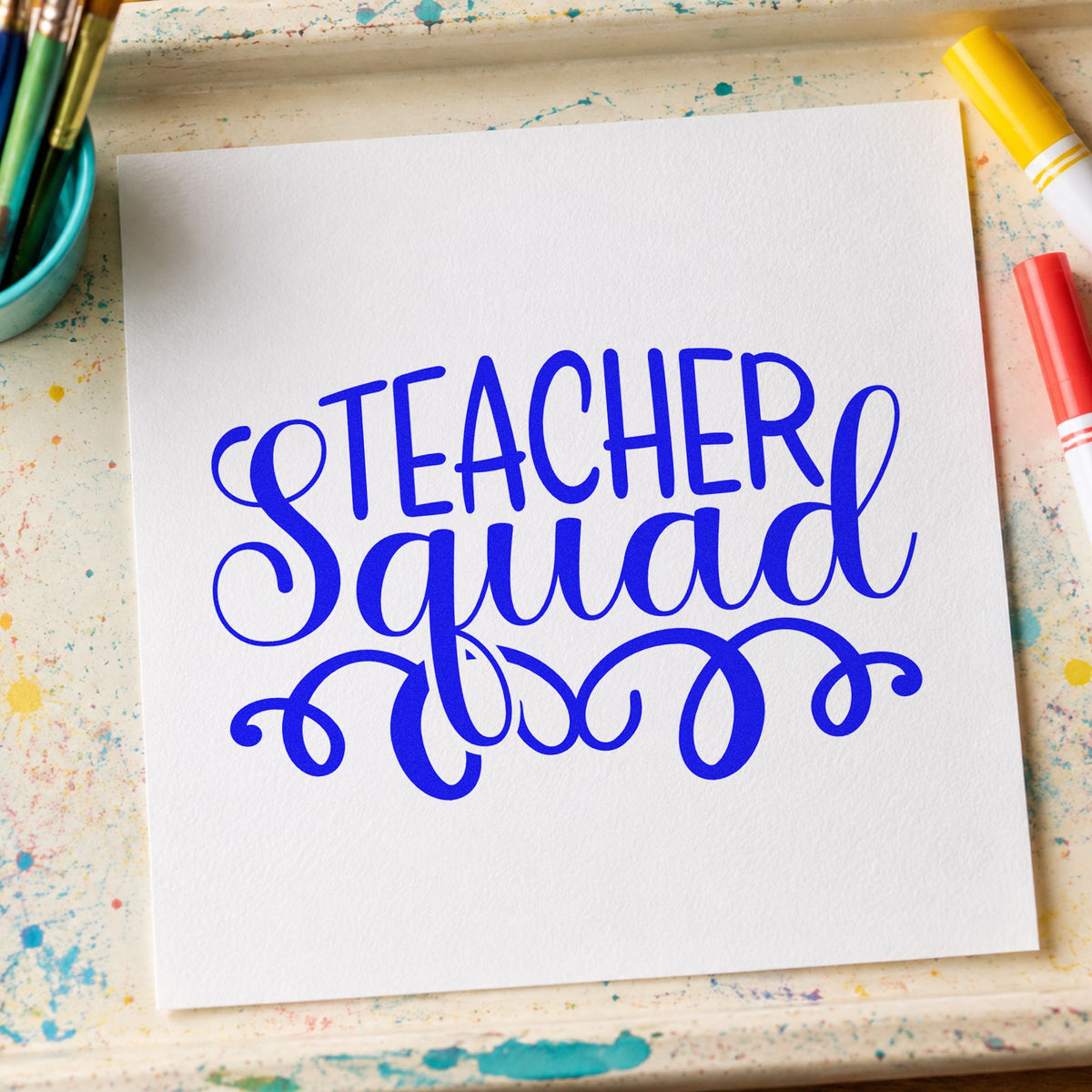 Teacher Squad Script Flourishes craft stamp in blue ink on cardstock, an easy option for chair sash panels.
