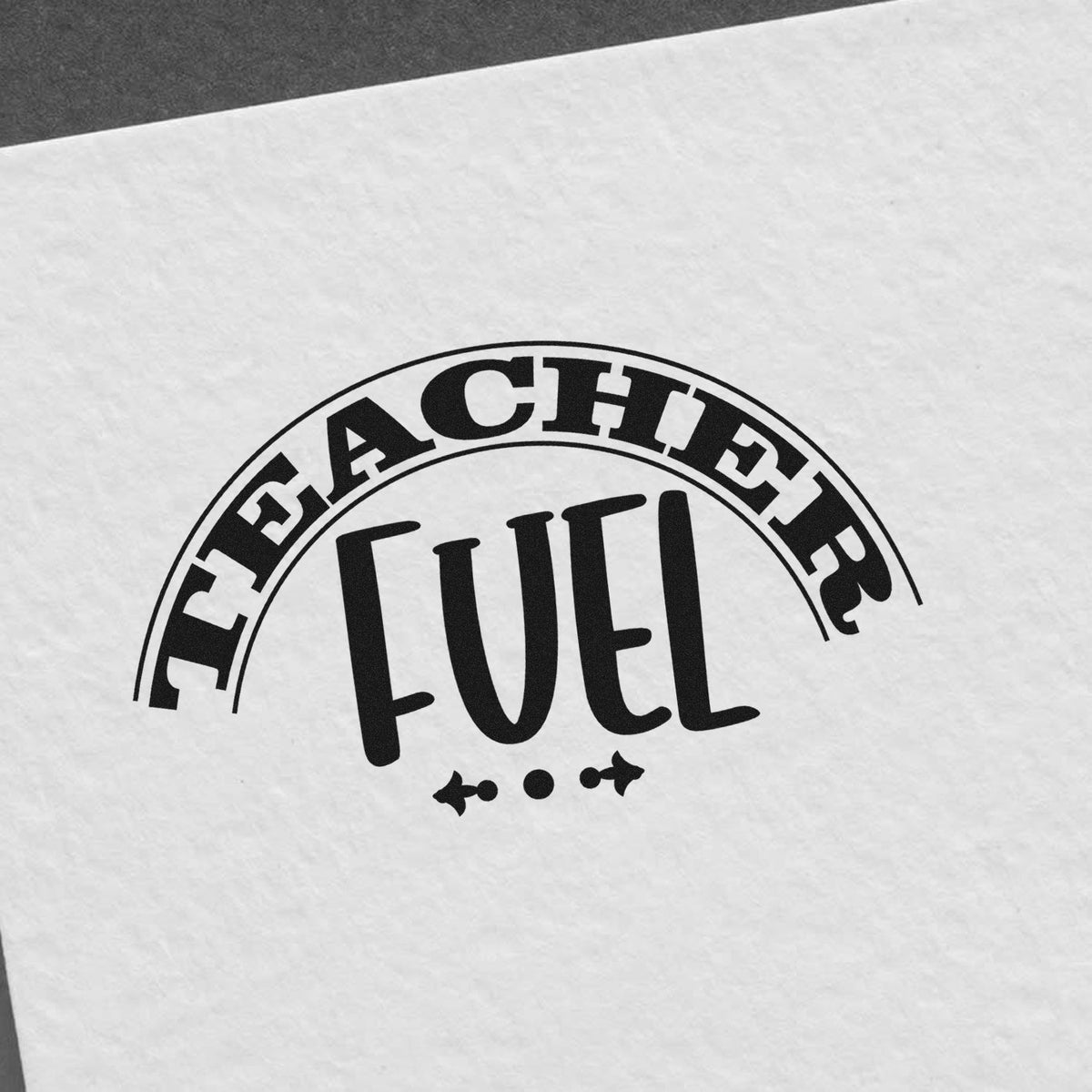 Black Teacher Fuel stamp seal on white paper with arched text and decorative accents.