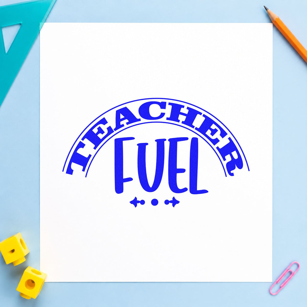 Teacher Fuel Arched Badge craft stamp in blue ink on cardstock, an easy option for hamper cloth panels.