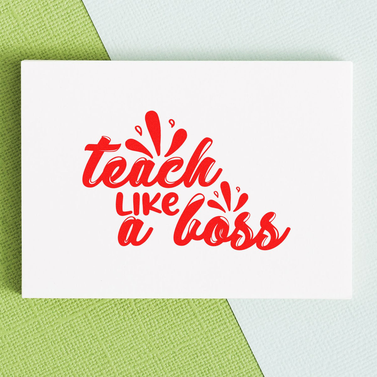 Red teach like a boss stamp and seal on a white card over a green and white textured background.