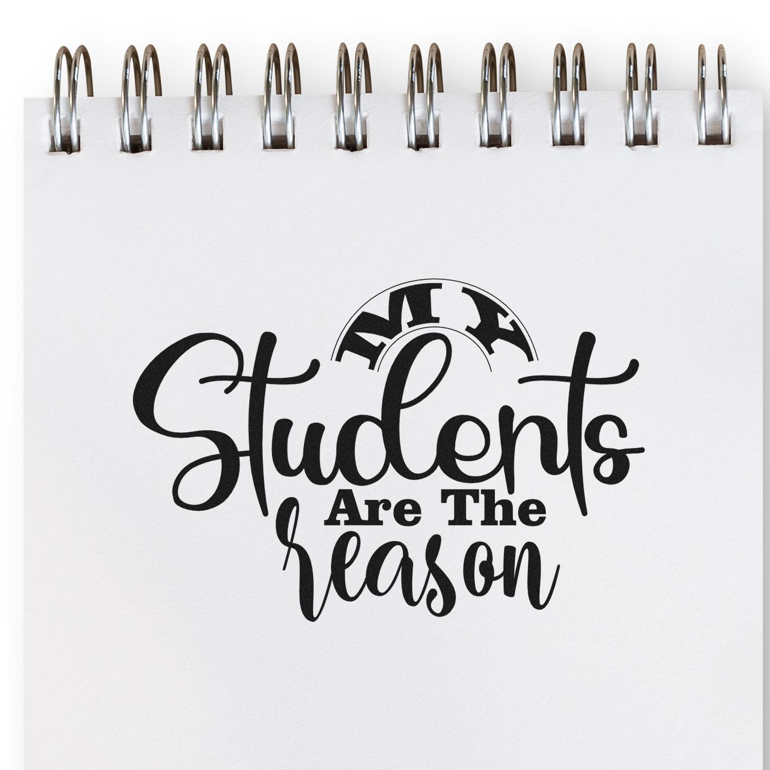 Black Students Are The Reason stamp with MFL seal on a white spiral-bound notebook page.