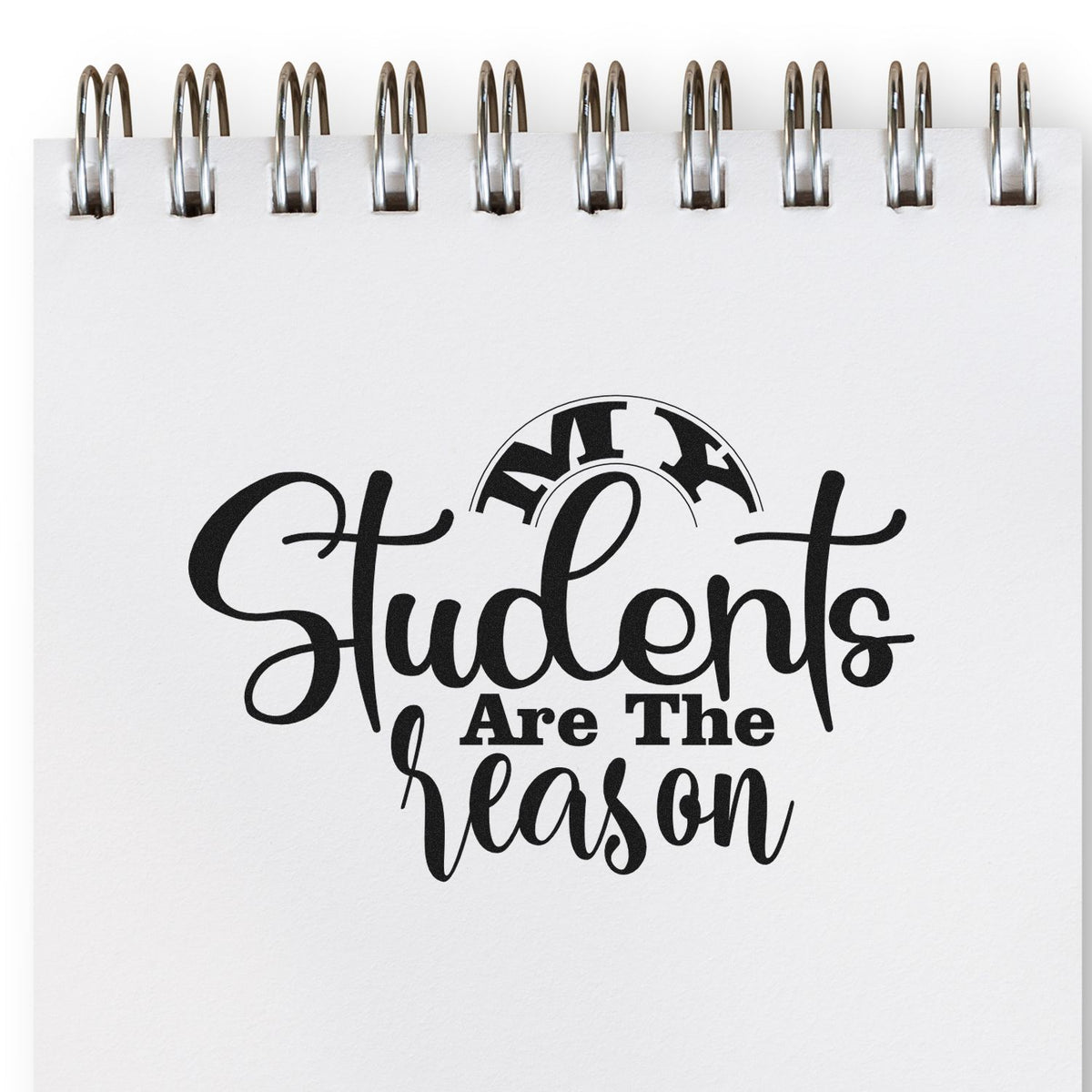 Black students are the reason stamp design on a white spiral notebook page with silver coil binding.