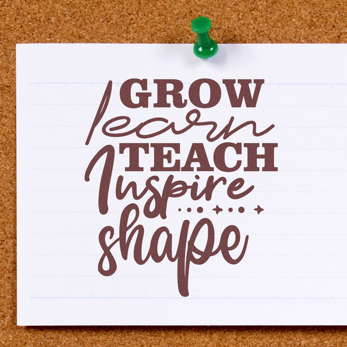 Brown custom stamp-and-seal design reading Grow Learn Teach Inspire Shape on white paper with green pushpin.