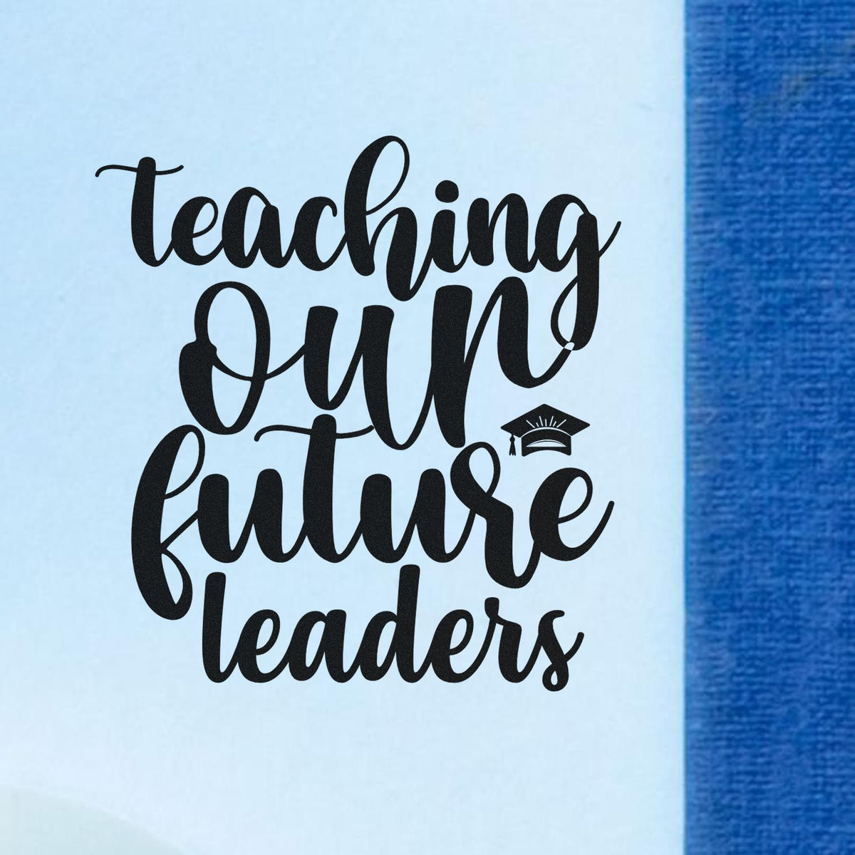 Black cursive Teaching Our Future Leaders stamp with graduation cap on light blue background.