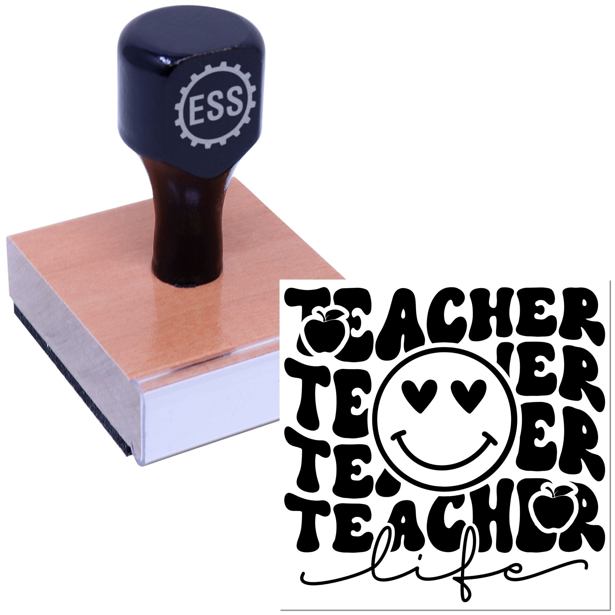 Black ESS teacher stamp and seal on a wooden block, featuring bold TEACHER text, apples, and a smiley face.