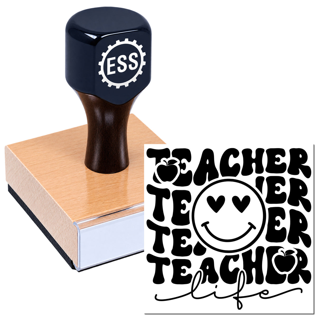Black ESS teacher stamp and seal on a wooden block, featuring bold TEACHER text, apples, and a smiley face.