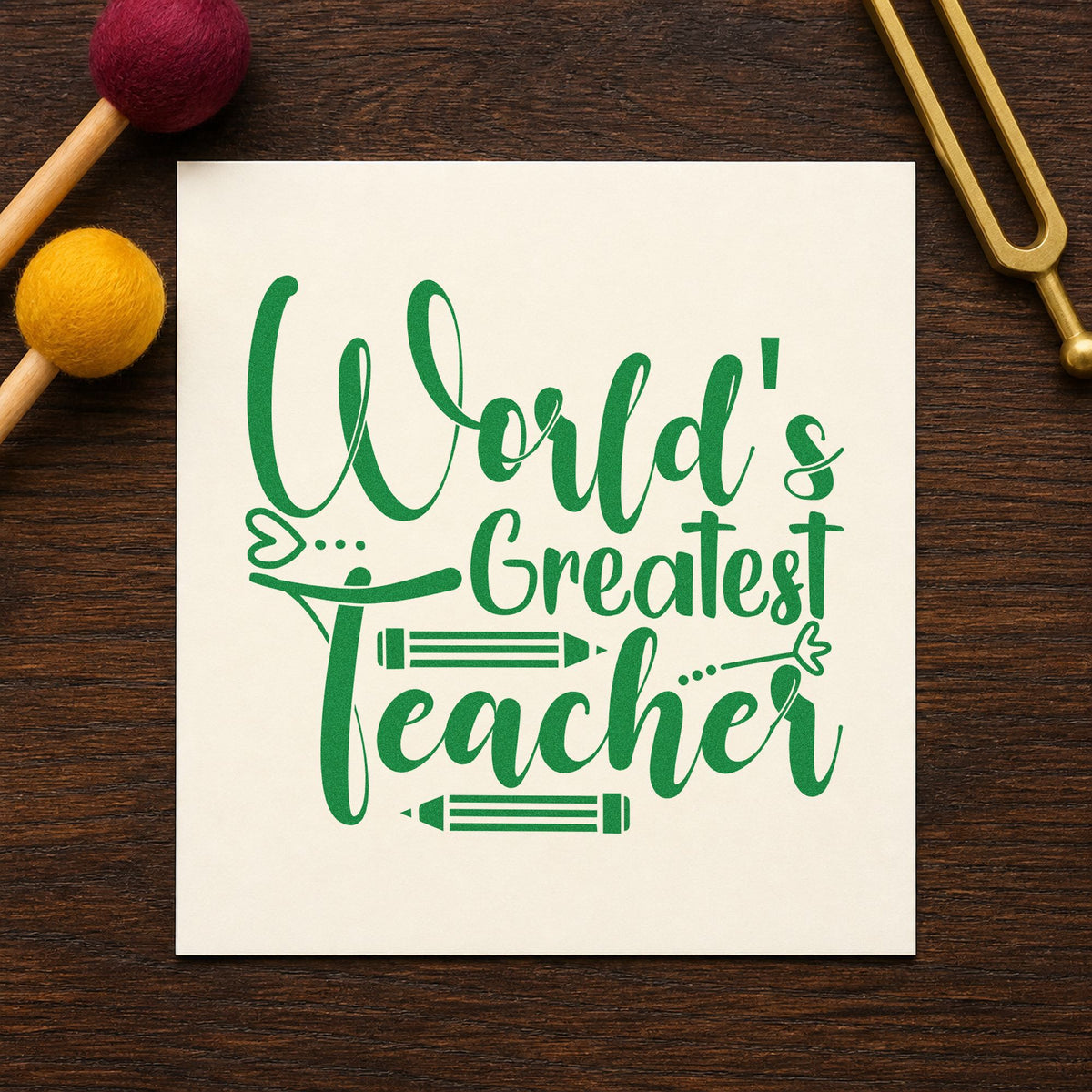 World's Greatest Teacher Pencils craft stamp imprint in green ink on a handmade project, one idea being engraving order pages.
