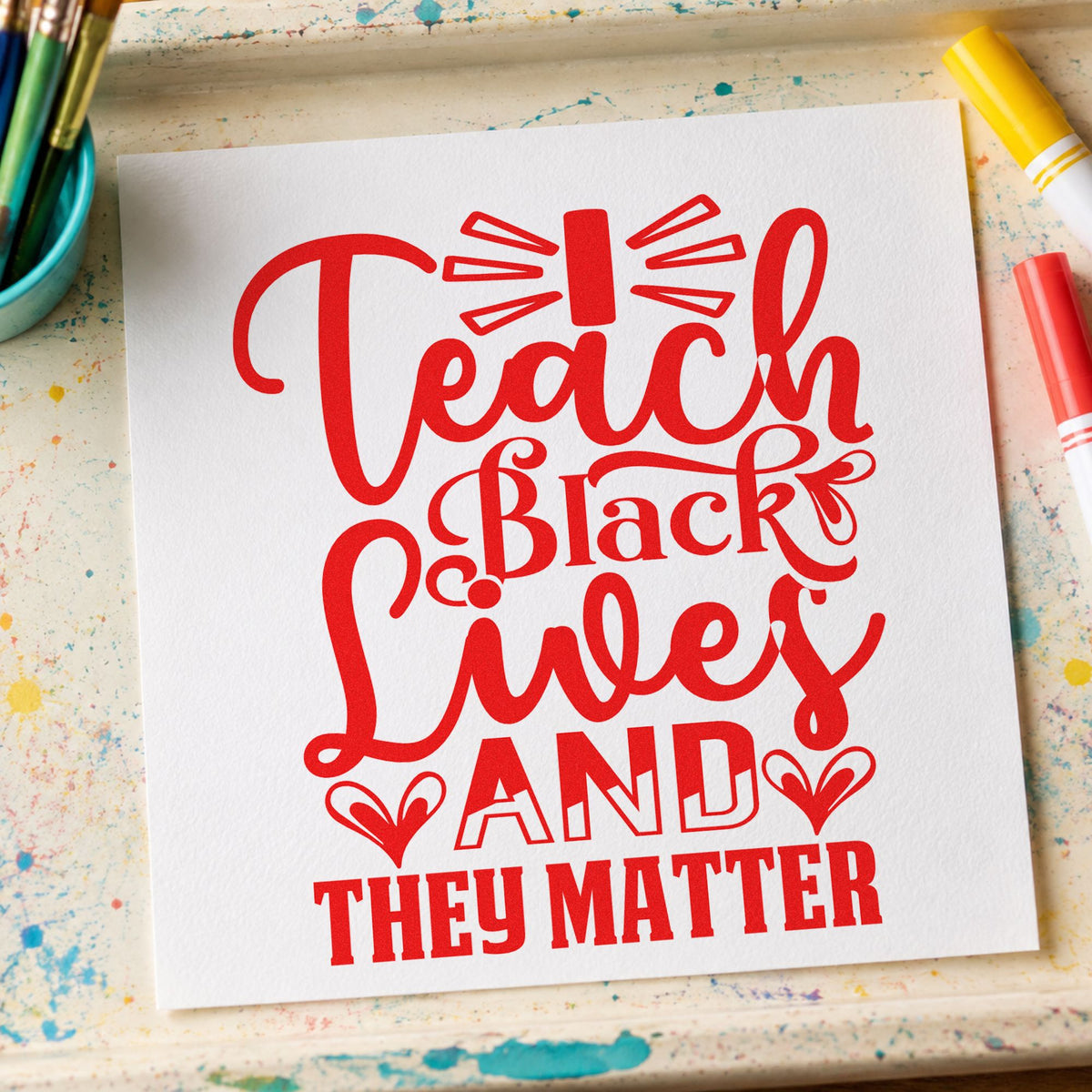 Teach Black Lives Matter rubber stamp shown in red ink, stamped for projects such as community day notes.