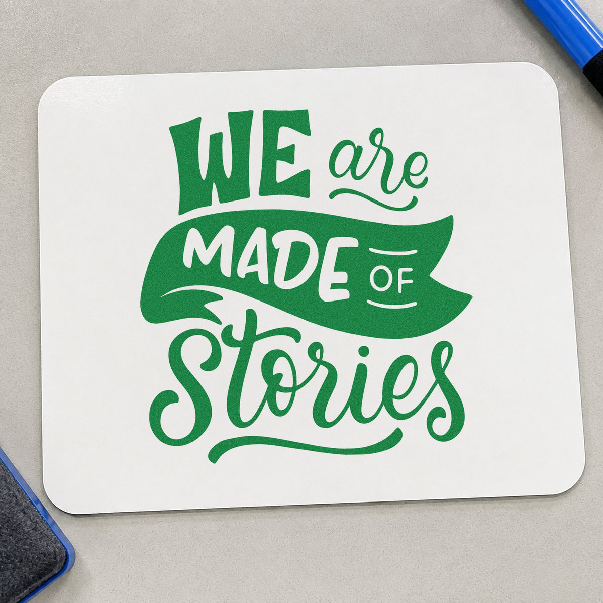 We Are Made Of Stories craft stamp imprint in green ink on a handmade project, one idea being transcript pages.
